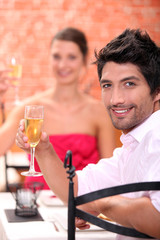 Couple toasting in restaurant