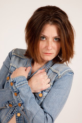 woman in blue jean jacket with arms crossed,