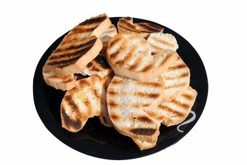 grilled slices of bread on a dish isolated on white background