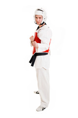 Young man inTaekwondo gear over white background.