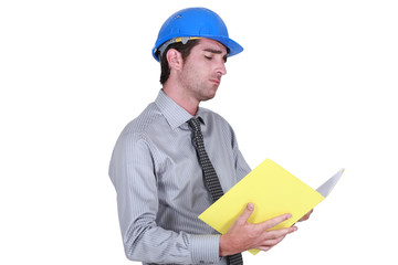 businessman wearing helmet taking notes