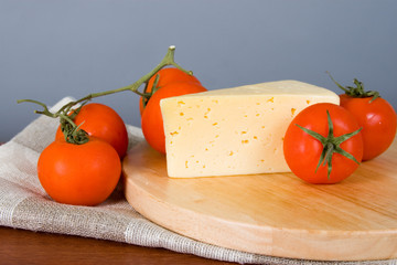 Yellow cheese with tomatoes