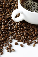 Cup of coffee on beans