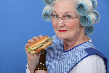 Granny eating a burger and drinking a beer