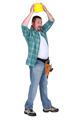 Construction worker putting on a helmet