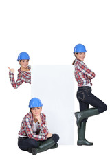 Female builder stood with advertising board