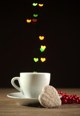 cup of coffee on wooden table on bright bokeh backdground