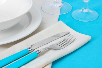 Table setting with fork, knife, plates, and napkin