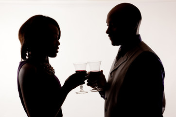 Silhouette of couple drinking wine together