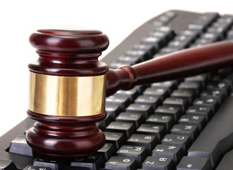 wooden gavel on keyboard isolated on white