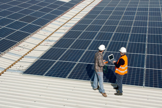 Men Working On A Photovoltaic Plant