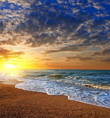 Fototapeta na wymiar dramatic sunset on a sea coast