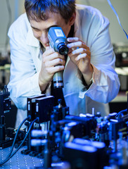 scientist doing research in a quantum optics  lab (shallow DOF;