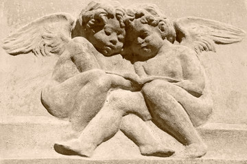 vintage image of two  angels  carved in clay