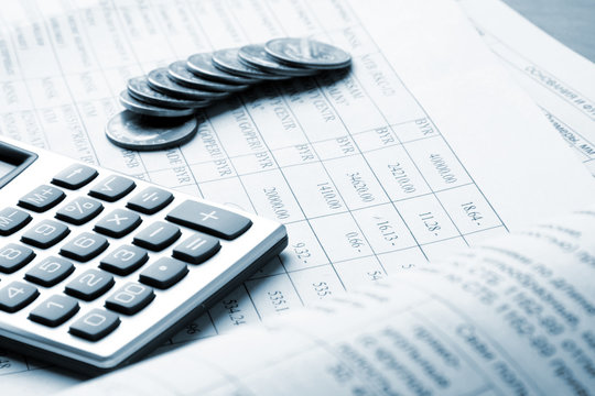 coins and calculator on business paper