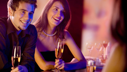 Young people with champagne at restaurant