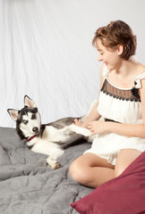 pretty woman with her pet husky dog