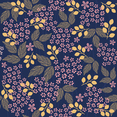 The pink flower and yellow leafs on dark blue background.
