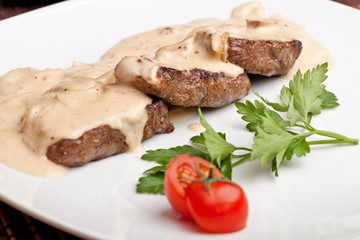 Roasted meat under white sauce