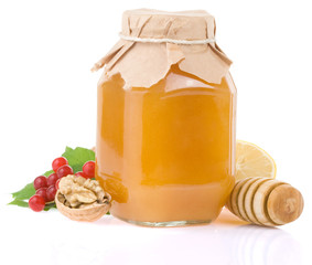 glass jar full of honey and fruit
