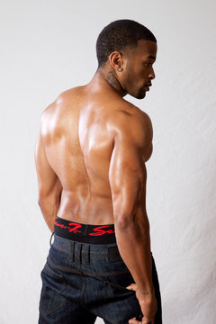 strong man toopless, showing his back