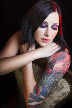 Portrait of young beautiful brunette with stylish  tattoo