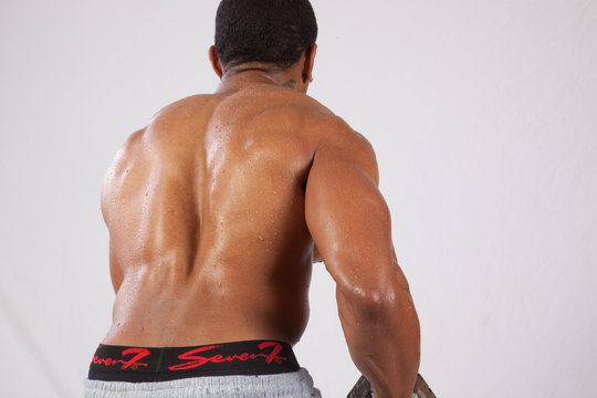 strong man toopless, showing his back