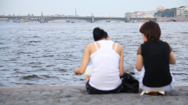 Two women on background of the river