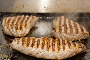 Steak on industrial grill