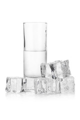 Frozen glass of iced vodka with ice cubes on white background