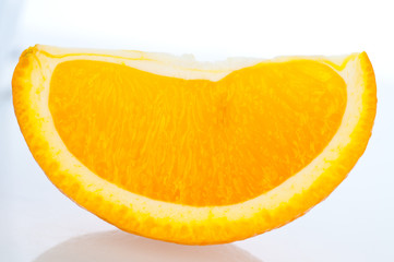 Fresh segments of an orange on a white background