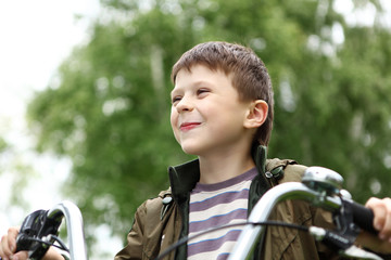 Boy on a bicycle in the green park