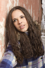 Fototapeta premium Portrait of the girl against an old wall