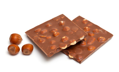 milk chocolate with hazelnuts isolated on white