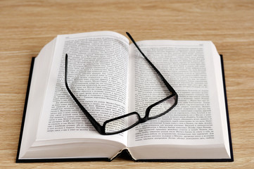 book and eyeglasses