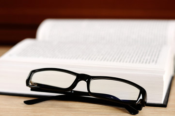 book and eyeglasses