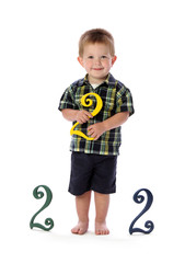 A Two Year Old Holds a Number Two