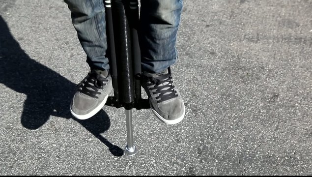Yong man jamping on a Pogo Stick