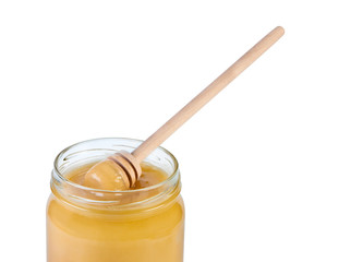 Jar honey and wooden spoon.