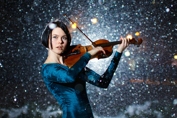 Girl with voilin on snow