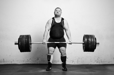Champion Powerlifter with strong arms lifting weights - obrazy, fototapety, plakaty