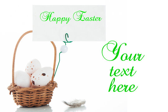 A small basket with eggs and a label for your text on white bacx