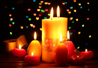 Beautiful candle and decor on wooden table on bright background