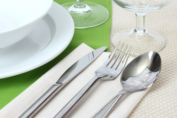 Table setting with fork, knife, spoon, plates, and napkin