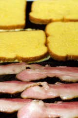 cooking French toast and bacon for breakfast