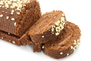 Chocolate Swiss roll closeup on a white background