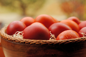 Red and Orange Easter Eggs in Wooden Bowl