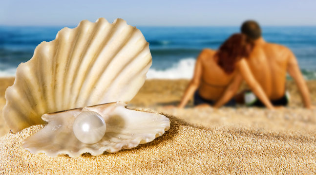 shell with pearl, couple on the beach