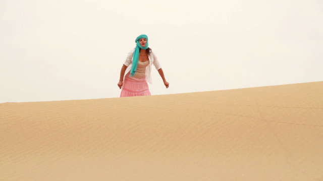 Lost woman walking and looking around in the desert