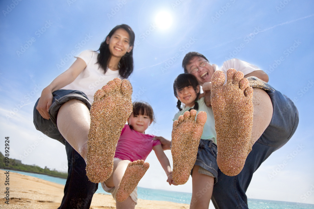 Wall mural happy asian family enjoy summer time on the beach